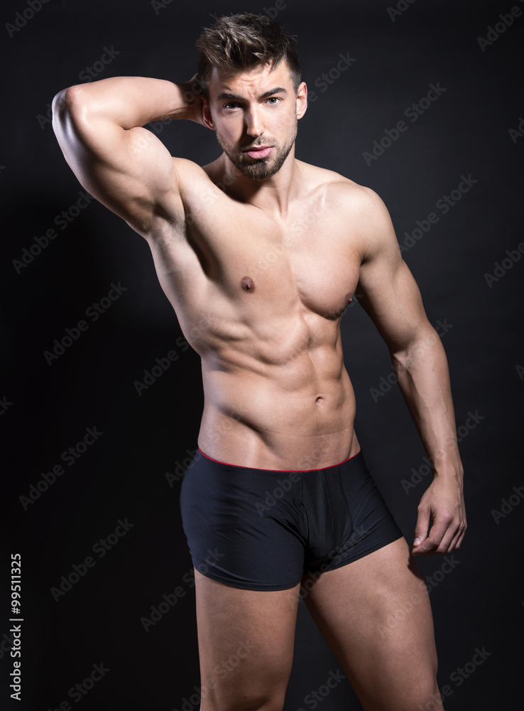 handsome young bodybuilder with toned body posing shirtless handsome young bodybuilder with toned body posing shirtless
