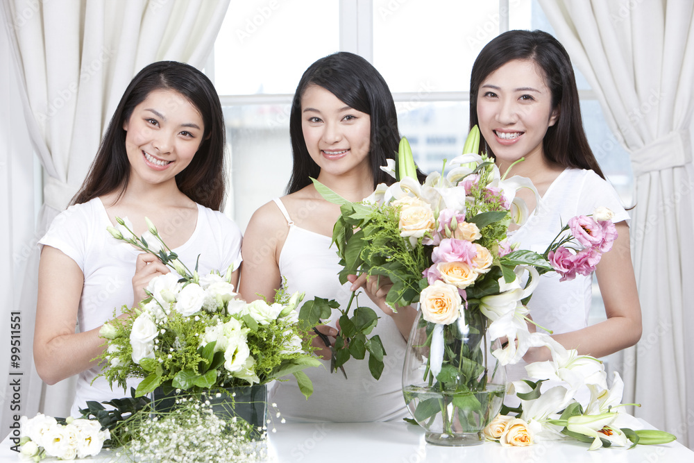 Best female friends arranging flowers together Best female friends arranging flowers together