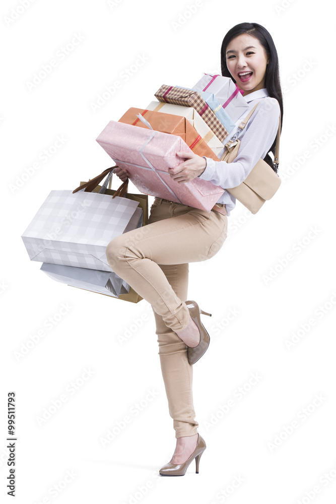 Young woman shopping with large group of boxes in hand Young woman shopping with large group of boxes in hand