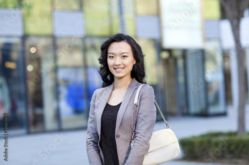 Happy young woman in city street photo