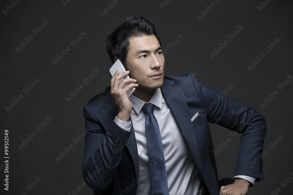 Confident businessman talking on the phone Confident businessman talking on the phone