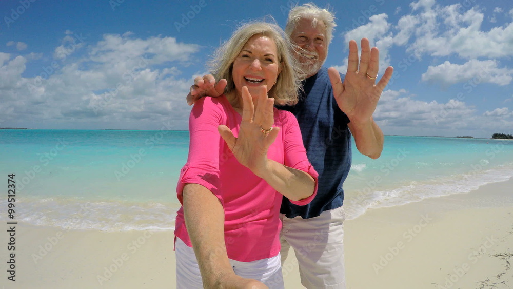 Senior Caucasian couple having fun on a beach taking a social media selfie Senior Caucasian couple having fun on a beach taking a social media selfie