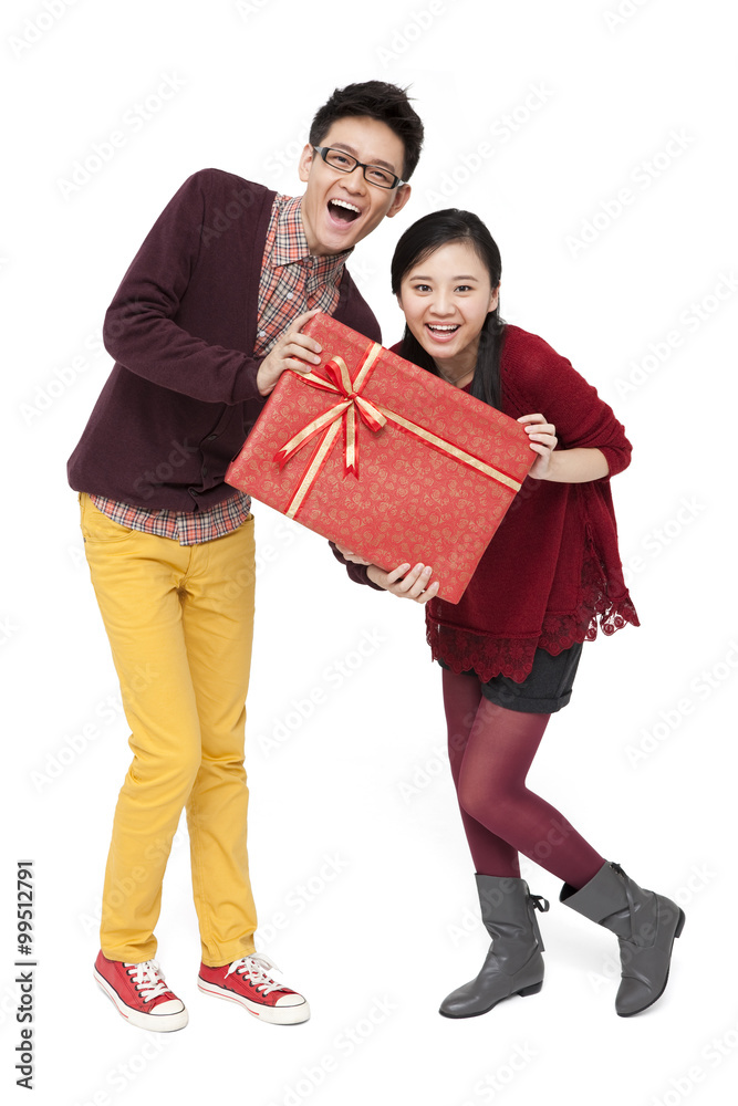 Happy young couple holding gift box for Chinese traditional New Year Happy young couple holding gift box for Chinese traditional New Year