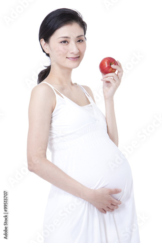 Healthy pregnant woman holding an apple