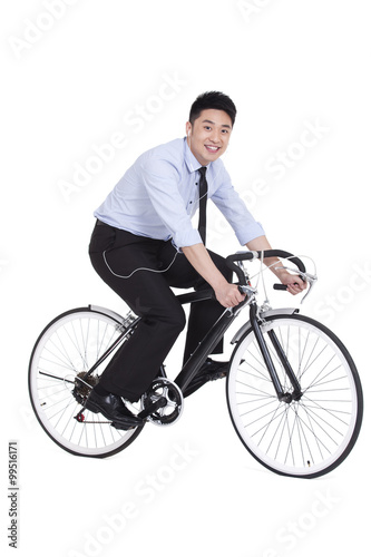 Fototapeta Naklejka Na Ścianę i Meble -  Cheerful young businessman on bike