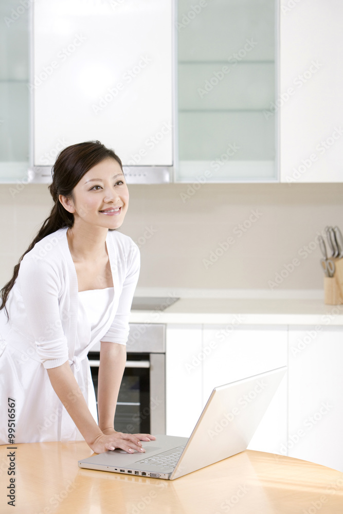 Young woman using laptop at home Young woman using laptop at home