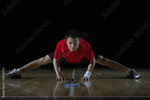 Young Man Stretching During A Game Of Badminton