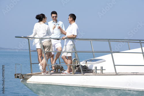 Friends Celebrating with Champagne on a Yacht © Blue Jean Images