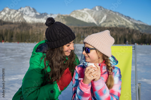 Mother and daughter enjoying winter vacations