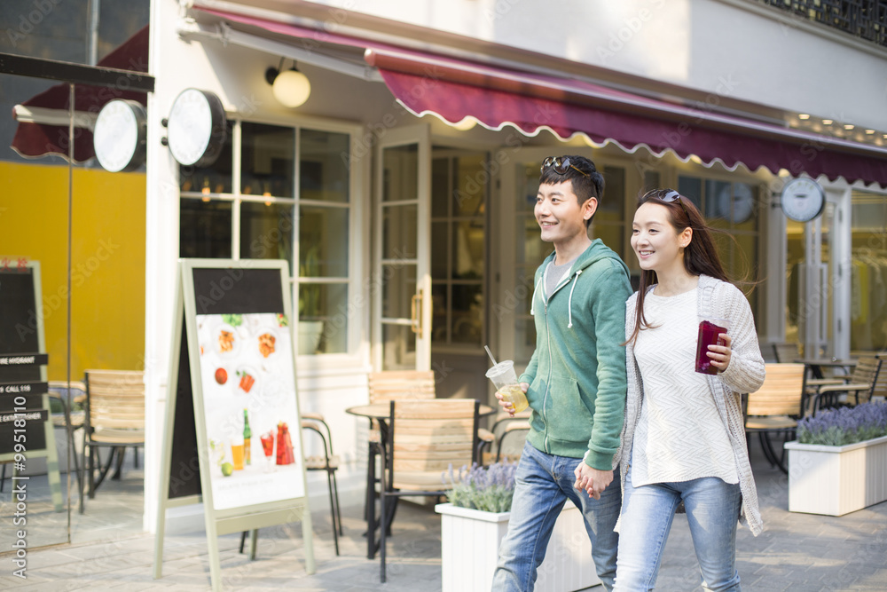Young couple holding hands walking Young couple holding hands walking