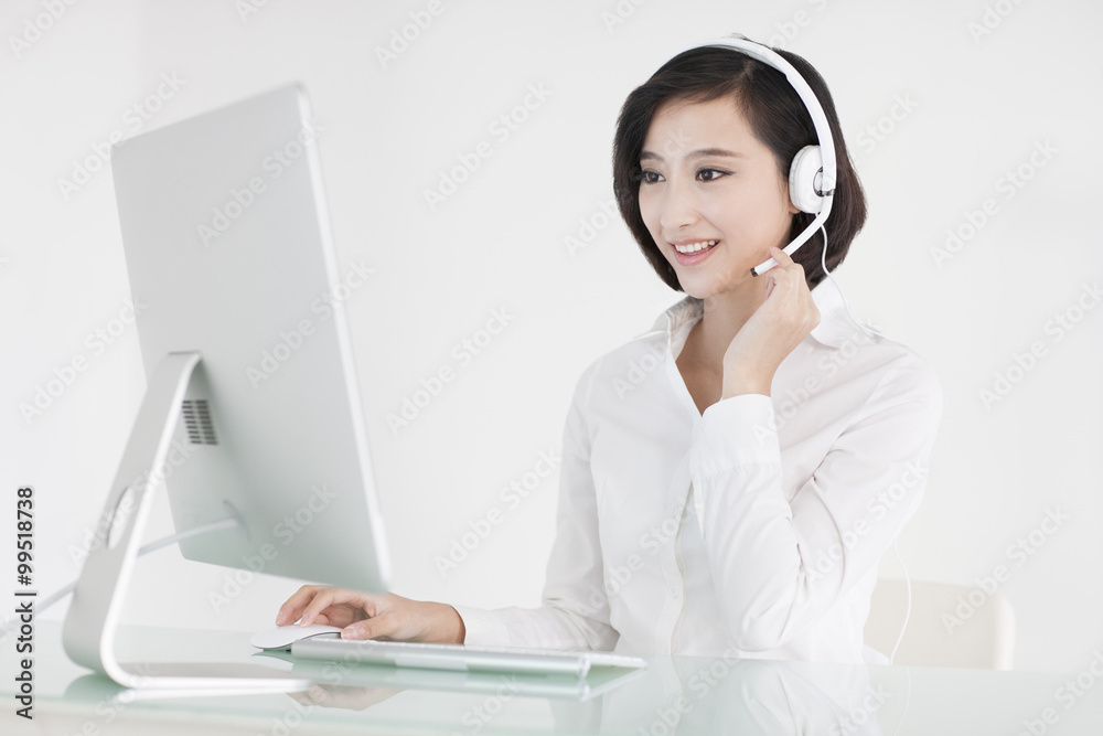 Cheerful businesswoman with headset in office Cheerful businesswoman with headset in office