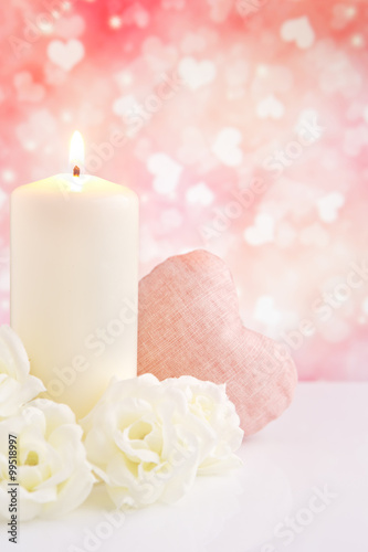 Valentine's hearts and candle with a bright background