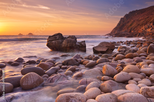 Rocky beach at sunset, Porth Nanven, Cornwall, England photo