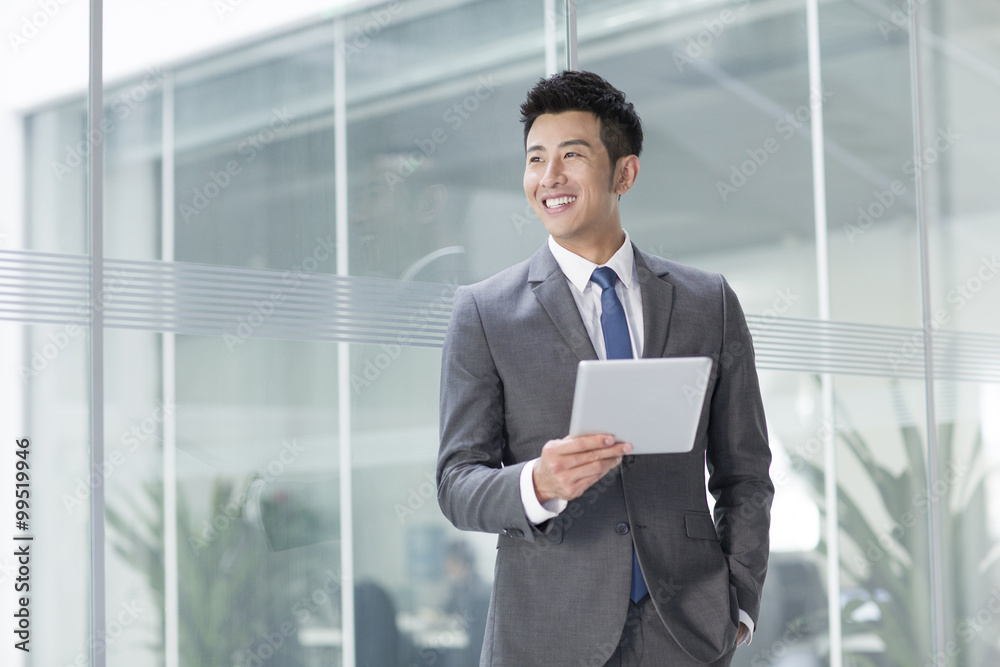 Fototapeta premium Young businessman with digital tablet