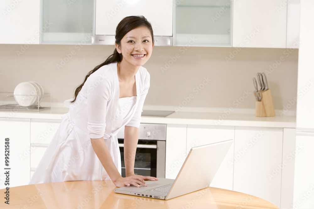 Young woman using laptop at home Young woman using laptop at home