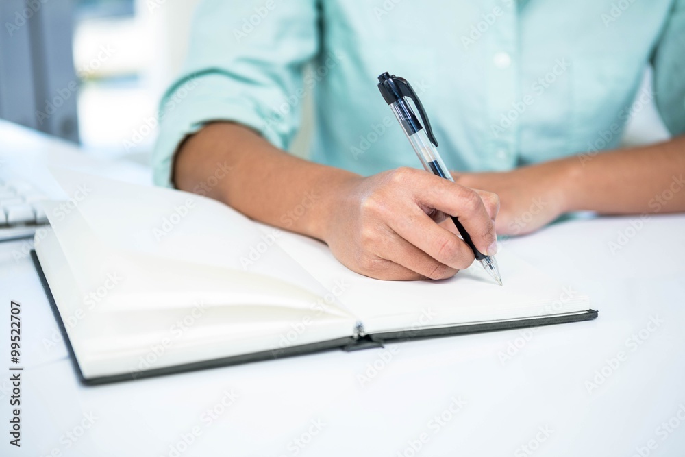 Close up view of a businesswoman writing notes Close up view of a businesswoman writing notes