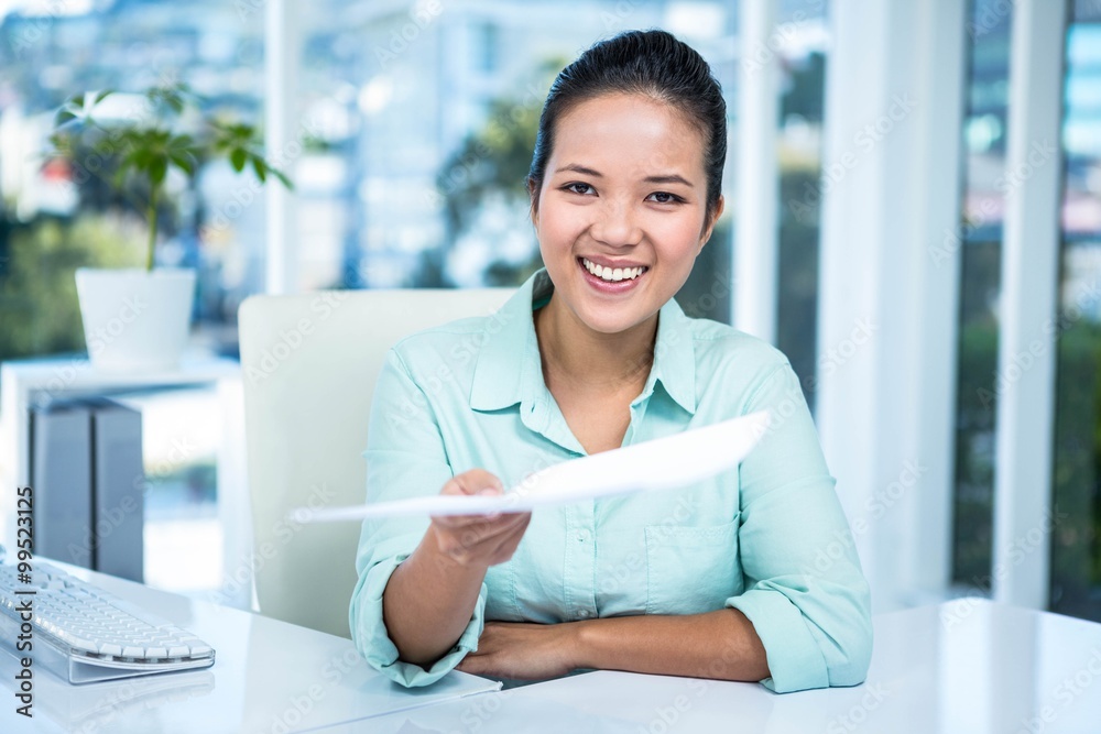Smiling businesswoman showing a paper Smiling businesswoman showing a paper