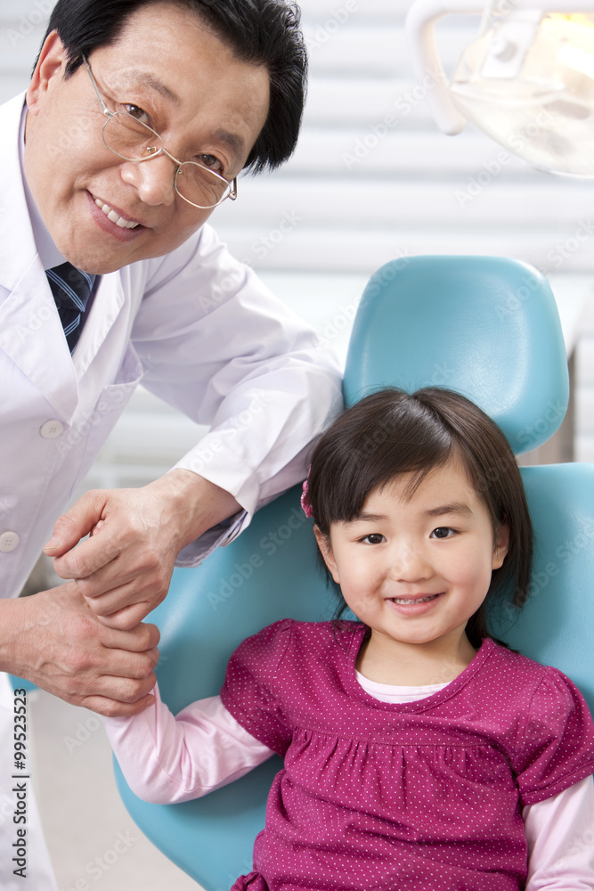 Dentist and little patient in dental clinic Dentist and little patient in dental clinic