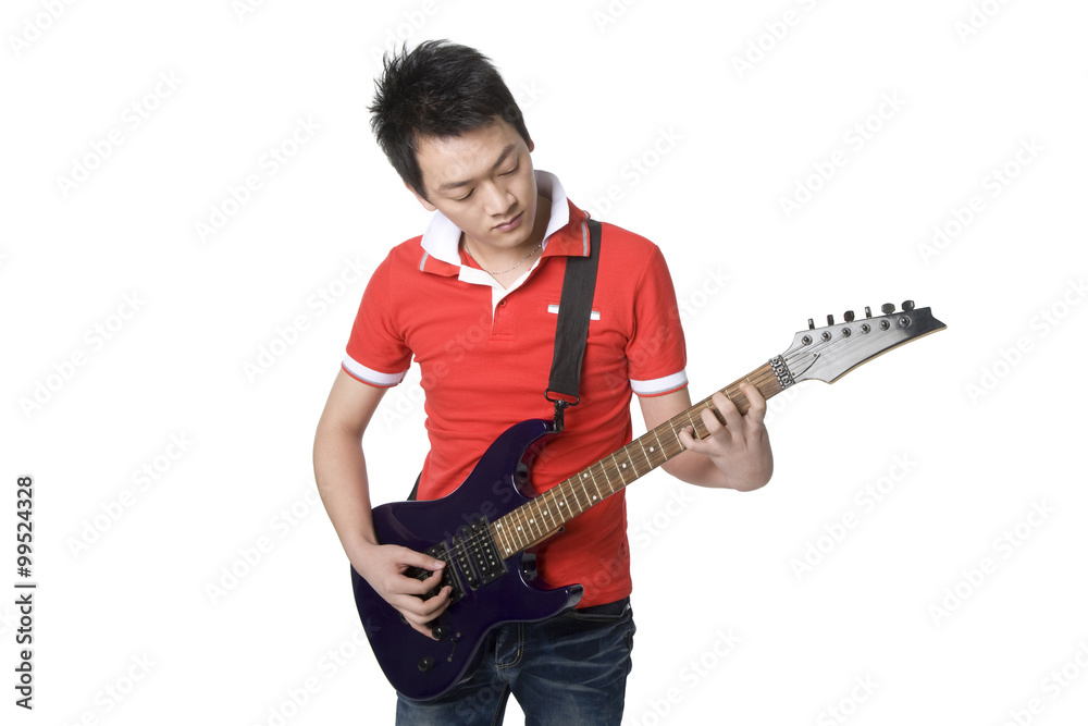 Young man playing an electric guitar