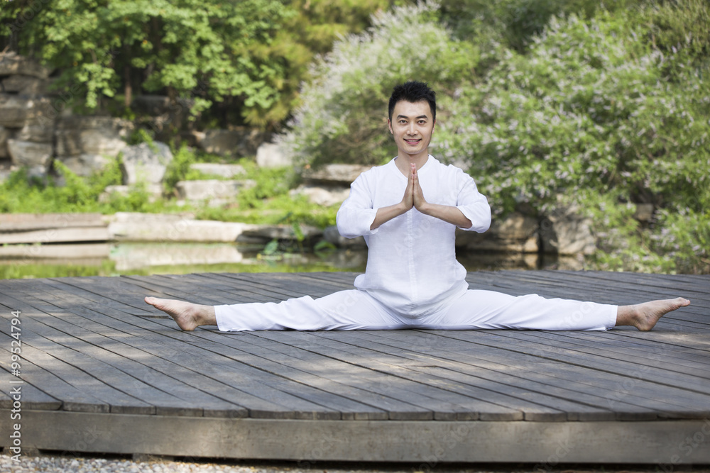 Fototapeta premium Young man practicing yoga