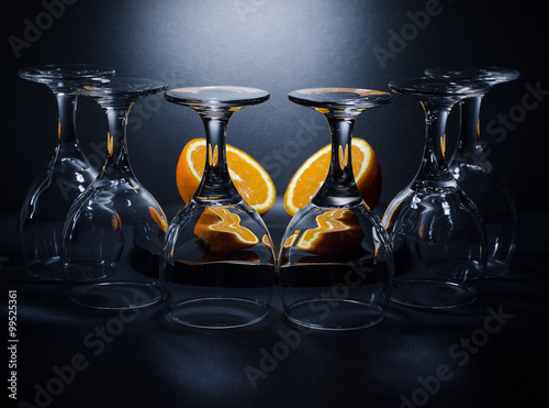 Glasses and oranges
Six upside down wine glasses and the two halves of the orange in the background.
