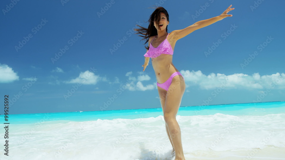Beautiful Asian Chinese girl in bikini on tropical beach Beautiful Asian Chinese girl in bikini on tropical beach