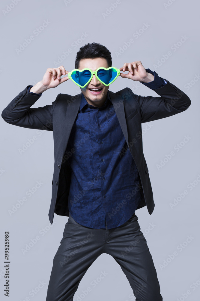 Hip young man wearing big sunglasses Hip young man wearing big sunglasses
