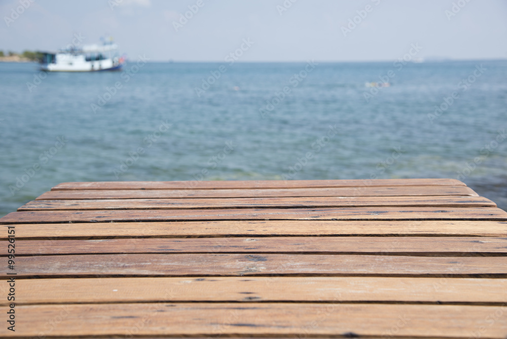 Wooden balcony on the sea background blurred background.