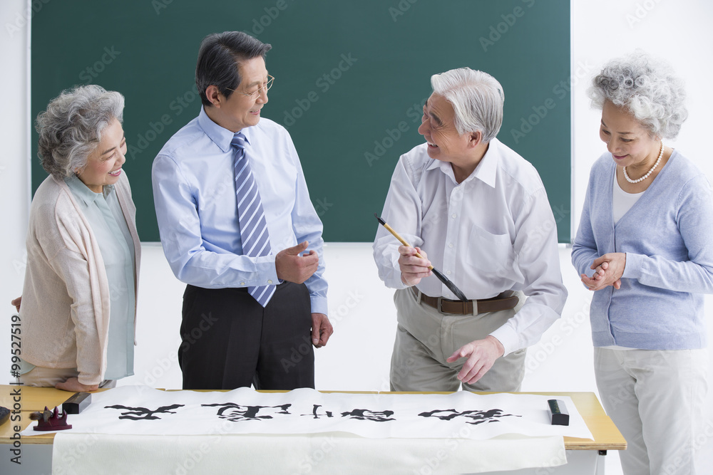Fototapeta premium Senior adults having calligraphy class at school