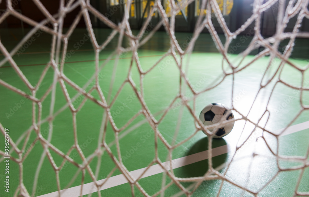 Backlit soccer ball in a goalpost