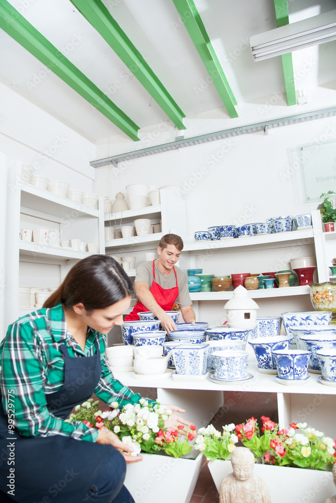 Man and woman working in a ceramics shop