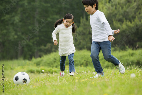 Happy children playing football together