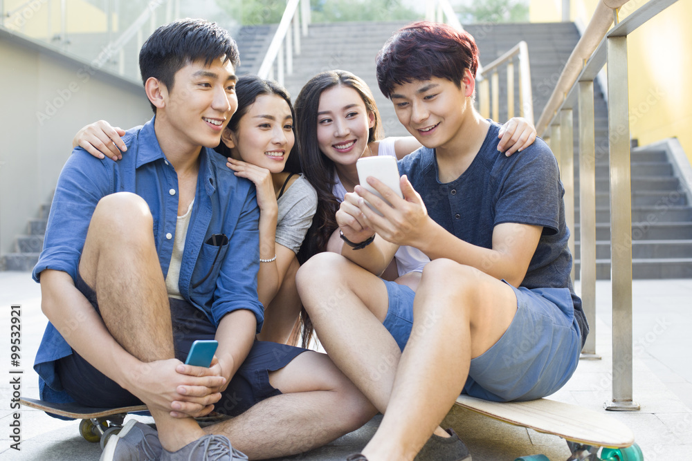Young friends looking at a smart phone Young friends looking at a smart phone
