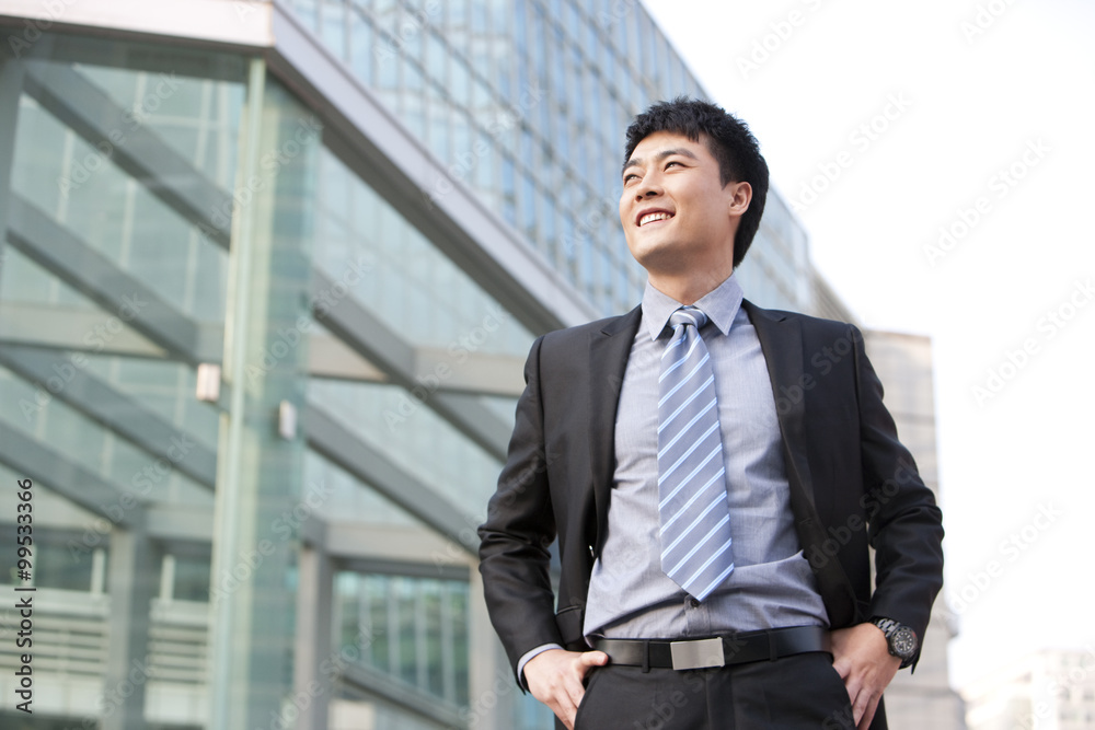Businessman by building exterior Businessman by building exterior