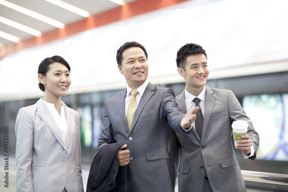 Cheerful business people at subway station Cheerful business people at subway station