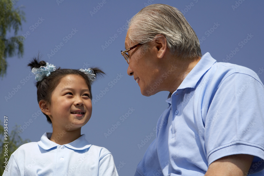 Granddaughter And Grandfather Looking At Each Other Granddaughter And Grandfather Looking At Each Other