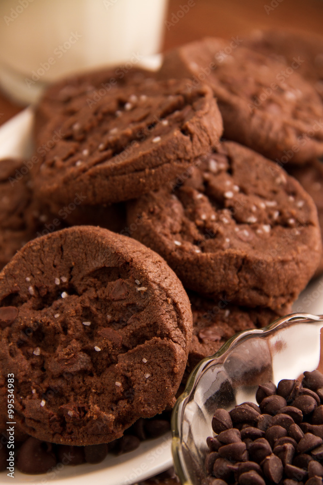 Chocolate cookie with bowl of chocolate chips Chocolate cookie with bowl of chocolate chips