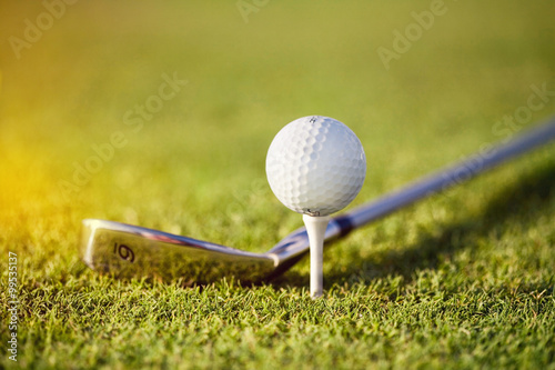 golf ball on tee with club