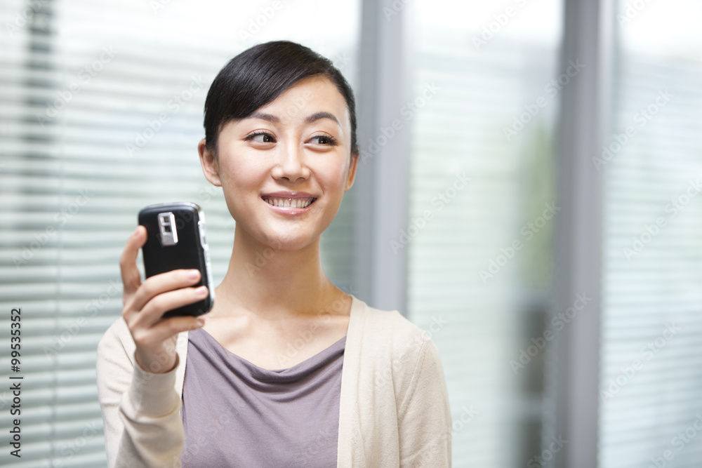 Confident Young Businesswoman Smiling at Phone Confident Young Businesswoman Smiling at Phone