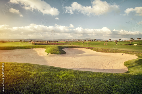Sand trap and bunker near a golf green