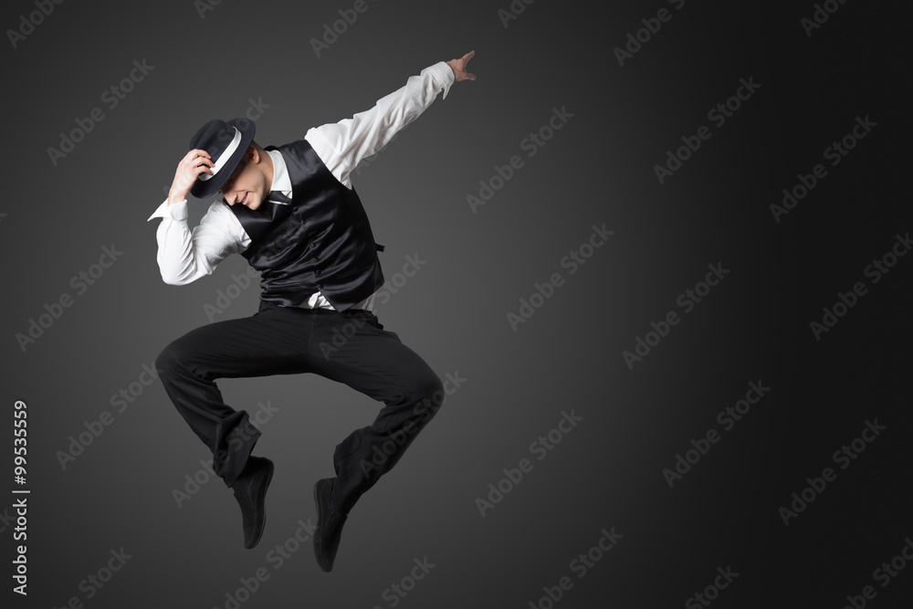 Young male professional dancer dancing in studio. - obrazy, fototapety, plakaty 