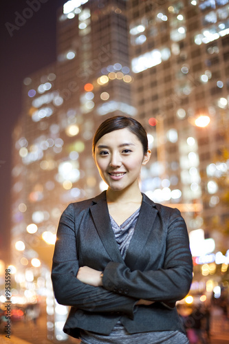 Chinese businesswoman with city lights in the background
