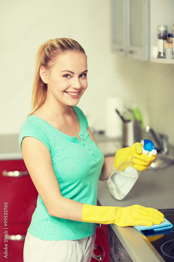 happy woman cleaning cooker at home kitchen happy woman cleaning cooker at home kitchen