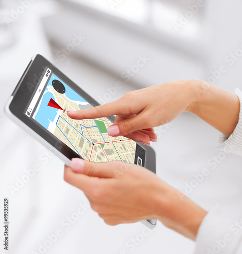 close up of hands with navigator map on tablet pc