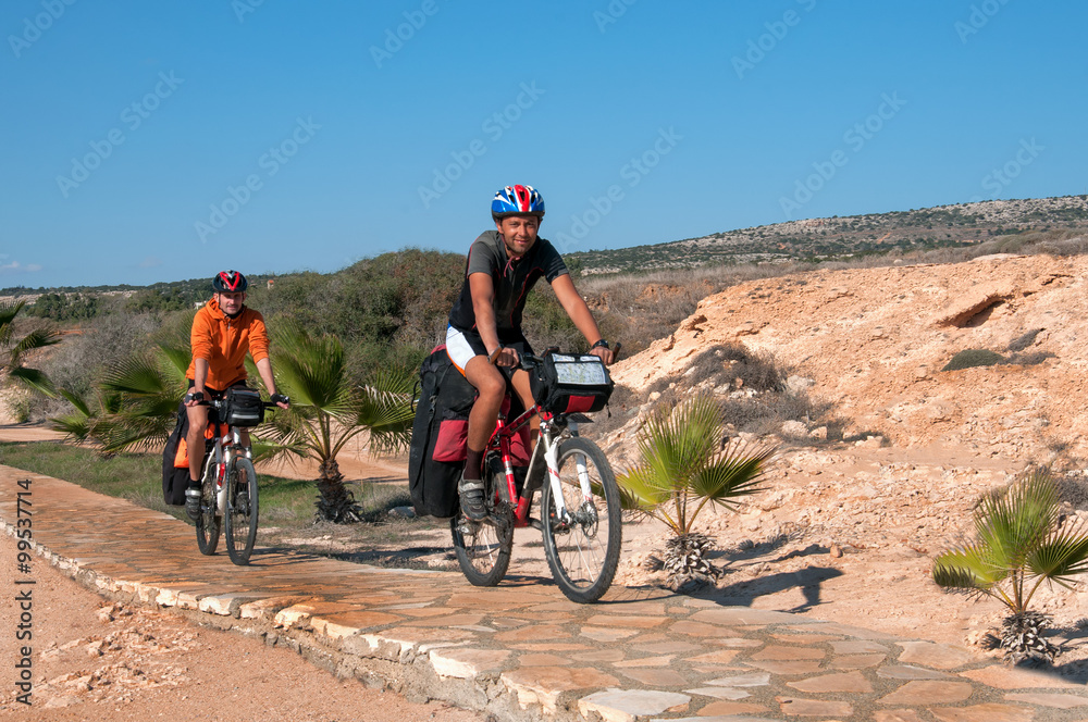 Fototapeta premium group of cyclists riding sandy beach mountain bike with backpack.