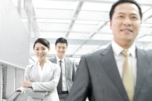 Confident business people in airport lobby