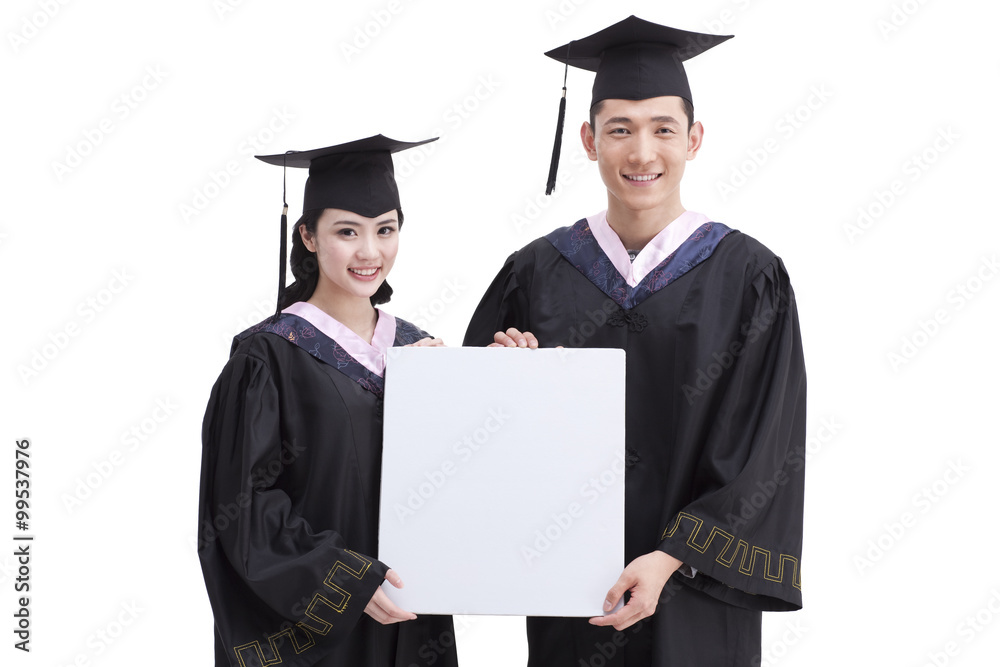 Happy college graduates with whiteboard