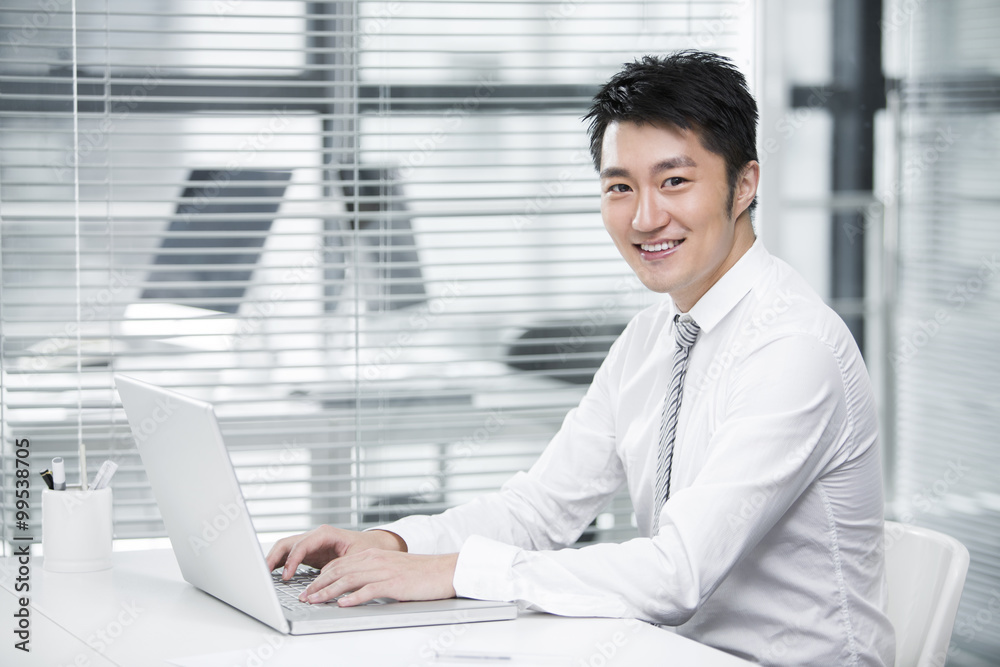 Young businessman using laptop