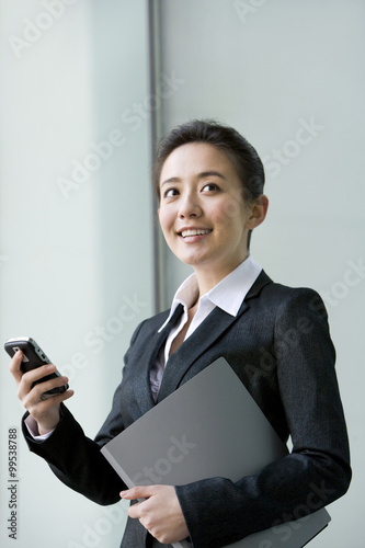 Businesswoman using the phone outside a building