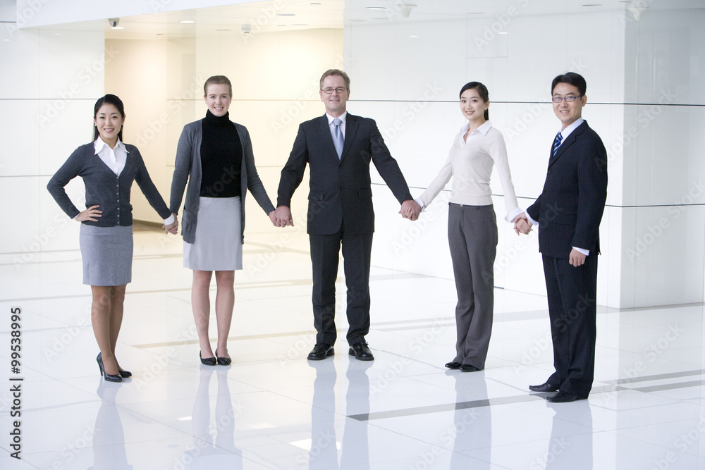 Businesspeople holding hands
